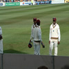 Dwayne Bravo and Denesh Ramdin share a smile on the field. Daren Ganga in back.